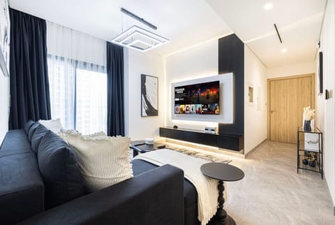 Bright, modern living room with plush seating, smart TV, and cozy touches—perfect for relaxing after a day out.