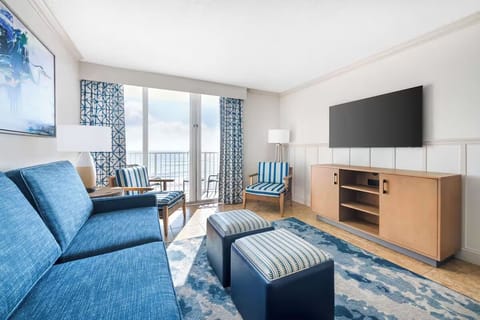 Unwind on the sofa as balcony light fills the room.