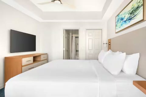 Settle into a spacious bedroom with soft lighting and serenity.