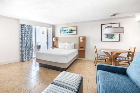 Stretch out in crisp bedding near the sunny dining nook.