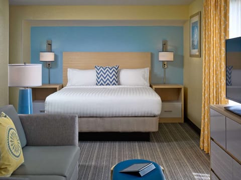 Unwind in a spacious suite with cozy seating and TV.