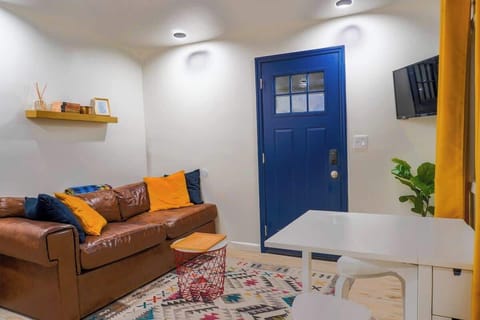 Cozy living room with comfortable seating and smart TV for relaxing after a day exploring the city.