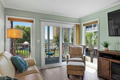 The magnificent windows allow the sun to shine into this comfy living room.