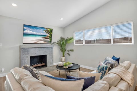 Cozy living room with fireplace, comfy seating & natural light ☀️