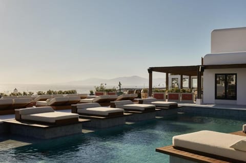 Dive into sunlit serenity with panoramic sea-view loungers.