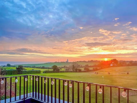Private balcony with seating and beautiful far-reaching views across the golf course and towards the Kent coastline, perfect for morning coffee or evening drinks.
