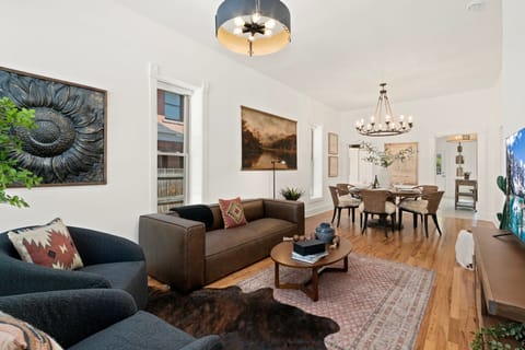 Unwind in your beautifully appointed living space, where modern comfort meets artistic flair with curated artwork and elegant furnishings.