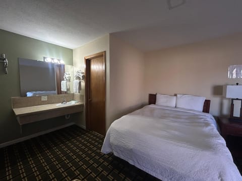 Settle in with convenient in-room vanity and cozy bed.