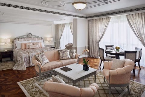 Unwind in a grand suite with elegant seating and light.