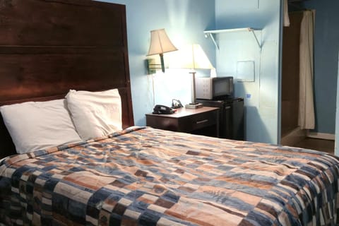 Unwind in a cozy bed with warm bedside lighting.