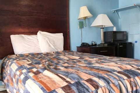 Recharge comfortably with bedside essentials and convenient in-room kitchenette.