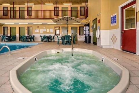 Recharge in the lively hot tub with poolside seating nearby.