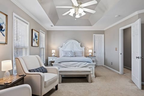 Bedroom 1: Relax in the bright and elegant primary suite with a queen comfort bed, cozy seating area, Smart Roku TV, large windows, dresser, walk-in closet, and pack n` play (always in unit).