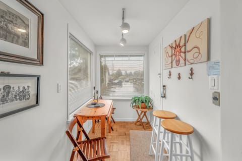 Your bright dining nook offers warm wood furniture and coastal artwork, perfect for morning coffee or casual meals together.
