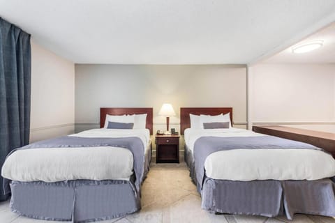 Unwind in a bright double-queen room with crisp linens.