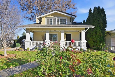 Charming Craftsman-style home with a spacious front porch and beautifully landscaped yard.