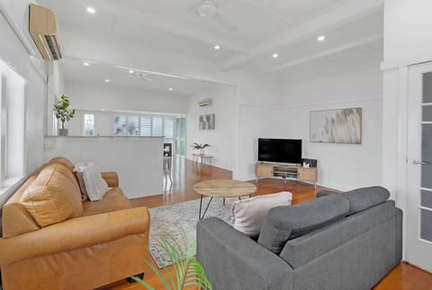 Settle into the living area, where high ceilings, soft natural light and comfortable seating create an inviting space to unwind with a movie.