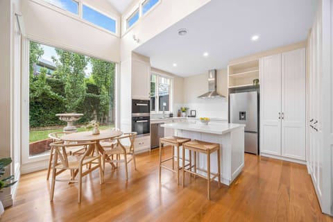 Light-filled open plan dining space and kitchen with breakfast bar.