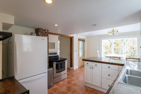 Kitchen and entry to hallway leading to living area and first floor bedroom