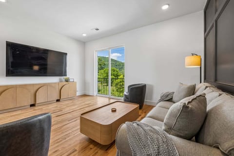 2nd Floor: Open concept living area with comfortable seating and TV + sleeper sofa (sleeps 2)