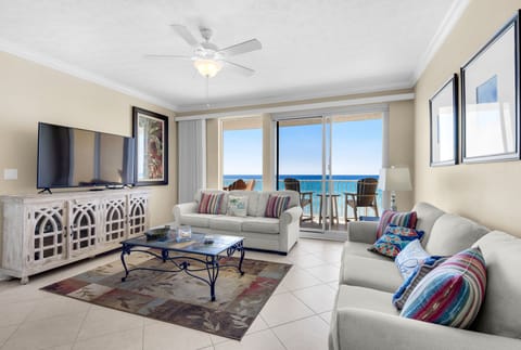 Relax in your bright oceanfront living room with stunning sea views, comfortable seating, and tropical coastal charm.
