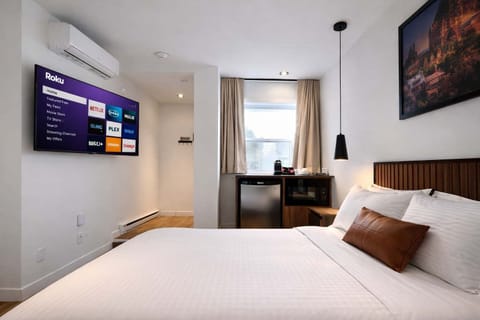 Détendez-vous dans ce studio lumineux et moderne, conçu pour un confort ultime. Ce refuge douillet comprend un lit queen-size moelleux, une grande télévision connectée avec services de streaming et un coin café pratique avec un mini-réfrigérateur.