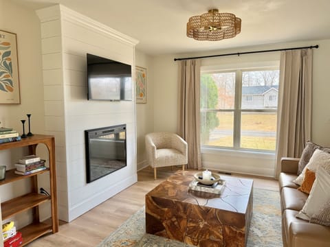 Bright, inviting living space with abundant natural light, a modern fireplace, and comfortable seating. The perfect place to relax and unwind after a day out