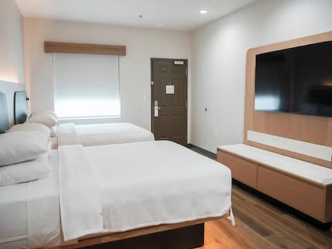 Stretch out on crisp linens in a spacious two-bed room.