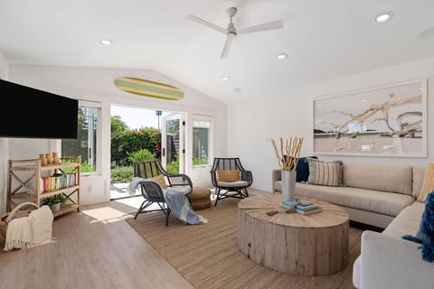 Primary living room with TV opens up to the garden with french doors