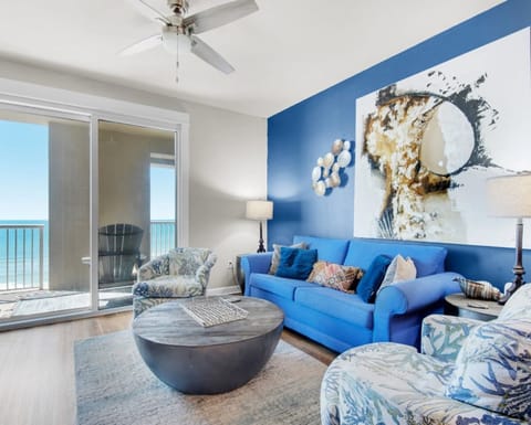 Unwind in your stylish living space where ocean blues meet modern comfort, complete with a ceiling fan and stunning sea views from your private balcony.