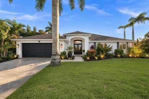 Casa Botanica - your private Naples retreat. From the moment you arrive, you’re greeted by lush tropical landscaping, a spacious oversized lot, and a charming, welcoming exterior that sets the tone for the relaxed, resort-style experience waiting 