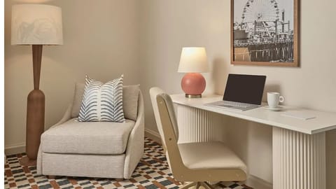 Sink into cloud-soft pillows beside a warm, modern nightstand.