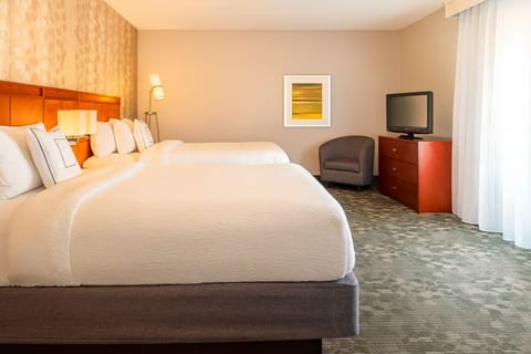 Sink into cozy double beds under warm, relaxing lighting.
