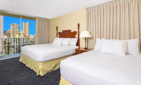 Stretch out on crisp beds beside sunny balcony city views.