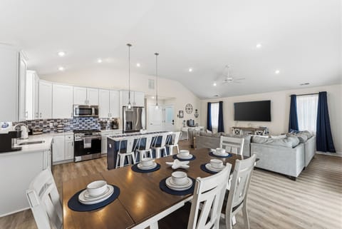 Bright open-concept kitchen, dining & living area with island seating