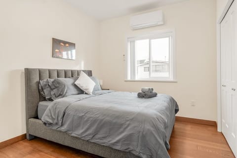 Bedroom 2 (2nd floor) with queen bed, desk, closet, ensuite, yard light.