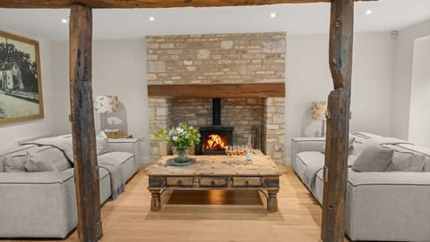 There are two three-seater sofas beside the fire where conversation thrives.