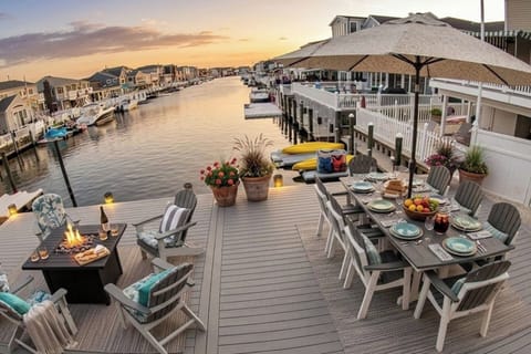 As the sun begins to dip over the private Lavallette lagoon, the "Sunset Lounge" comes to life. Sink into the Adirondack chairs around the flickering fire pit. It’s the perfect spot to toast to the day while the kids watch the boats