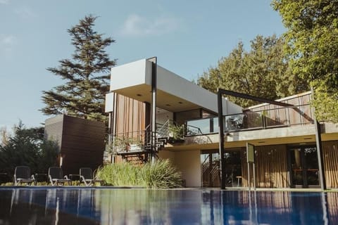 Relax on loungers beside the serene, mirror-like pool.