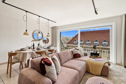 Spacious open living room with a comfortable corner sofa and dining area