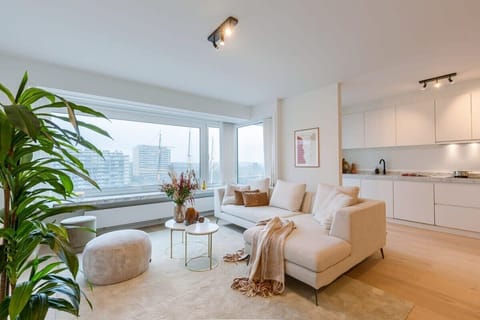 Modern living room with large windows offering city views and natural light