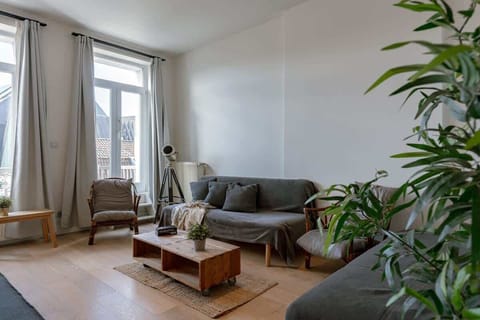 Bright living room with natural light and modern wooden furniture