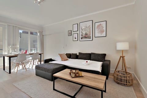 Modern living room with a sectional sofa and natural light from large windows