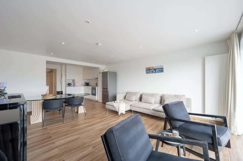 Modern open-plan living area with a spacious kitchen and comfortable seating.