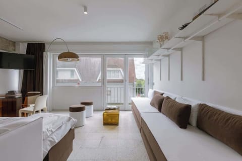 Modern living area with a long sofa and natural light from large windows
