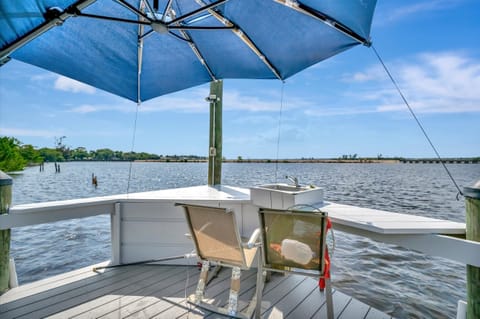 Waterfront balcony with umbrella seating and views