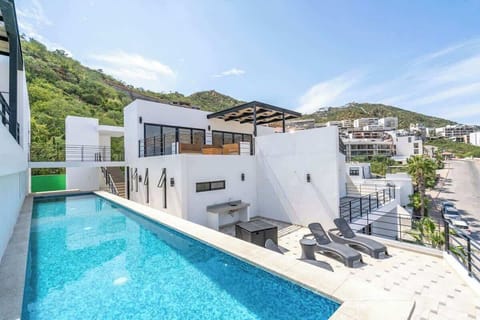 Poolside terrace w/ sun loungers & hillside views, perfect for soaking up the sun