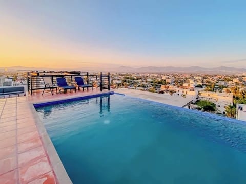Shared rooftop pool w/ panoramic city views, perfect for a refreshing dip at sunset