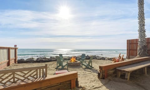 Beachfront firepit lounge area with ocean views and seating