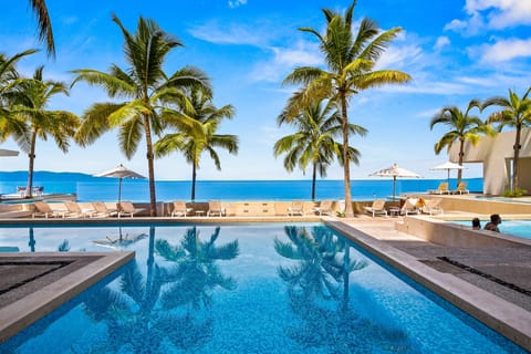 Relax in a stunning oceanfront pool surrounded by palm trees and breathtaking tropical views — the perfect place to unwind and enjoy unforgettable sunsets.